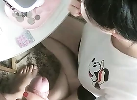 Asian girlfriend gives bf a blowjob while she does her make-up